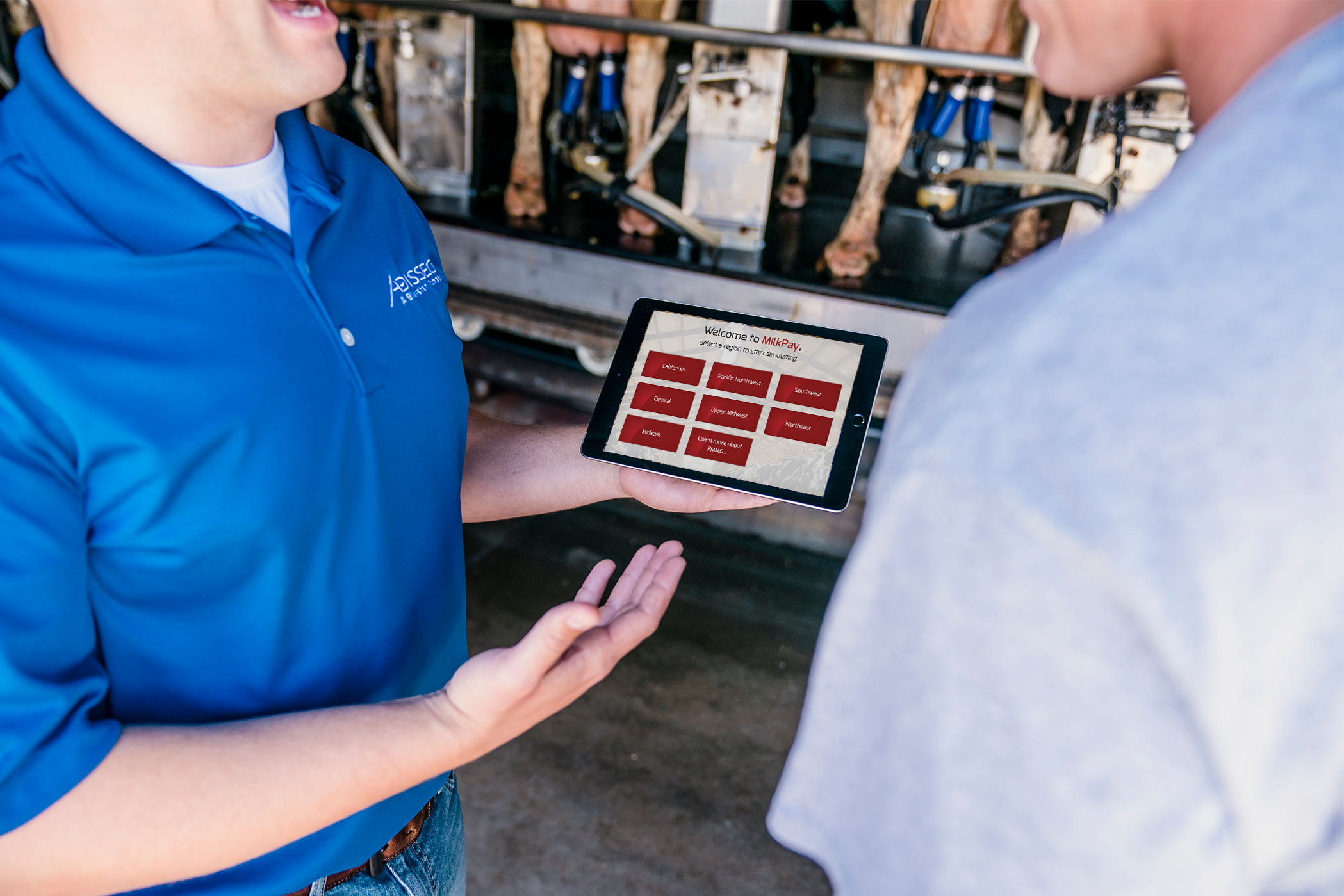 Adisseo employee demonstrating the Milk Pay App to the man
